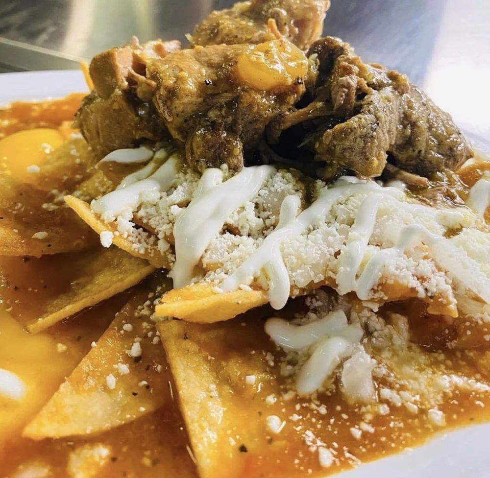 Chilaquiles Deluxe topped with meat, Cotija and crema