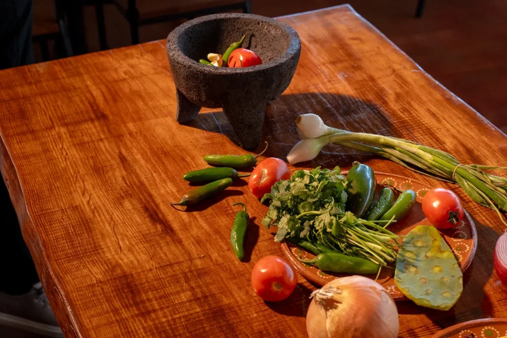 Fresh chiles, tomatoes, cilantro and a molcajete on the restaurant’s wooden table